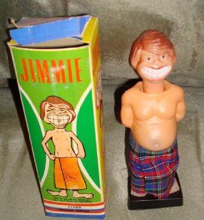 JImmy Carter 7 1/4" caricature doll. "The Peanut Man, " huge Carter grin. Nude except for a towel wrapped around his mid section. Push down on his head and a very large peanut springs out from under the "towel" from between his leg