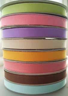large spool of ribbon by paper and string